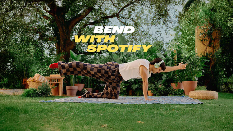 the Fitness on Spotify hub shows a man doing a yoga pose with headphones on