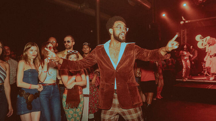 A crowd in 1970s attire.