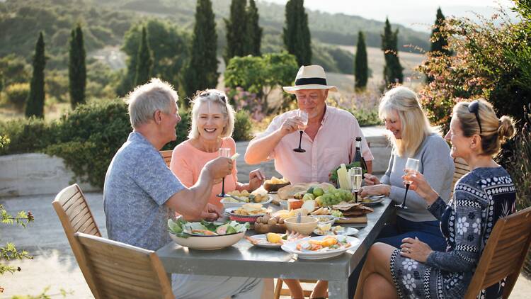 A table of people in the Italian countryside