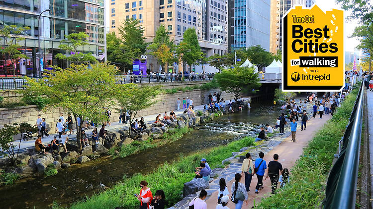 People walking along Cheonggyecheon Stream in early autumn Seoul