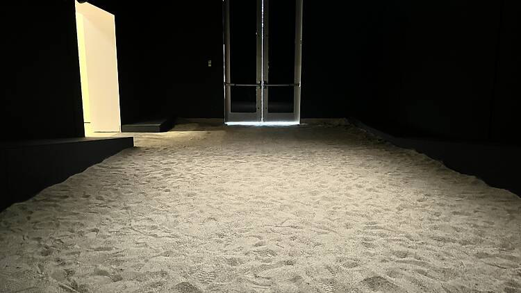 A room filled with sand at the end of “Several Eternities in a Day: Form in the Age of Living Materials.”