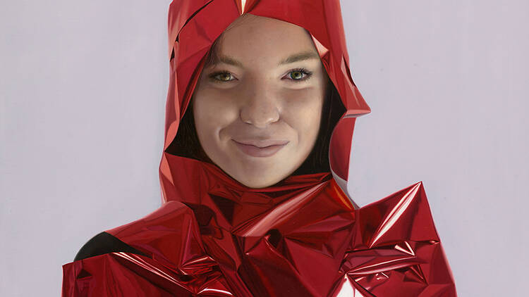 A detailed life-like portrait of actress Chloé Hayden wrapped in red ribbon