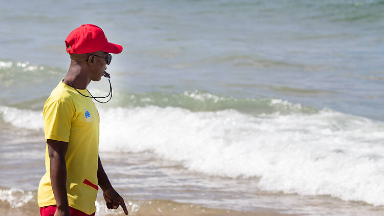 A south african male lifeguard watching the sea in Durban, South Africa.