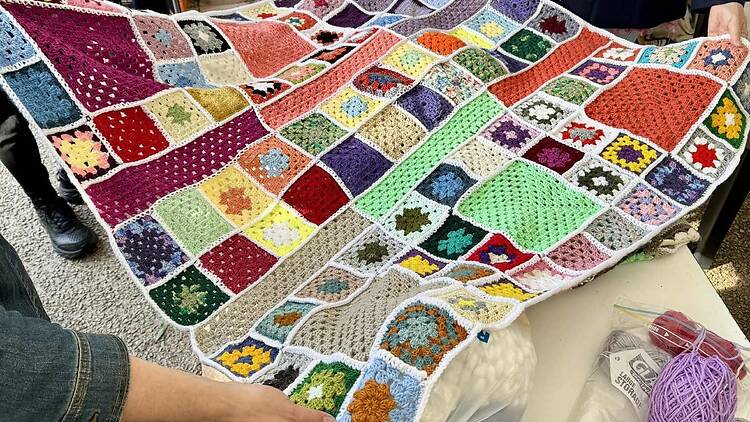 people admiring crochet blankets at Frankston South Side Festival