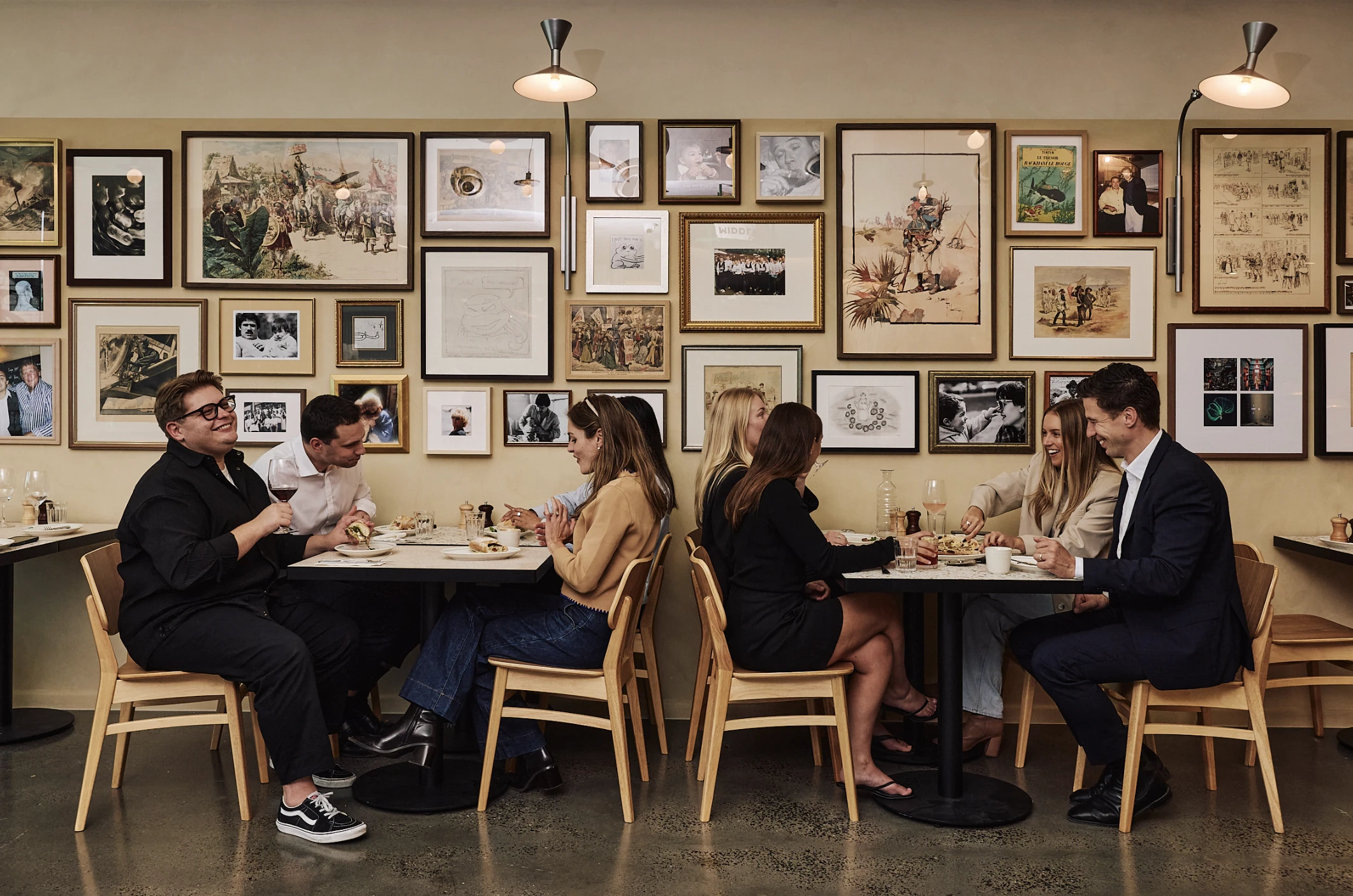 People dining and laughing together at tables inside restaurant