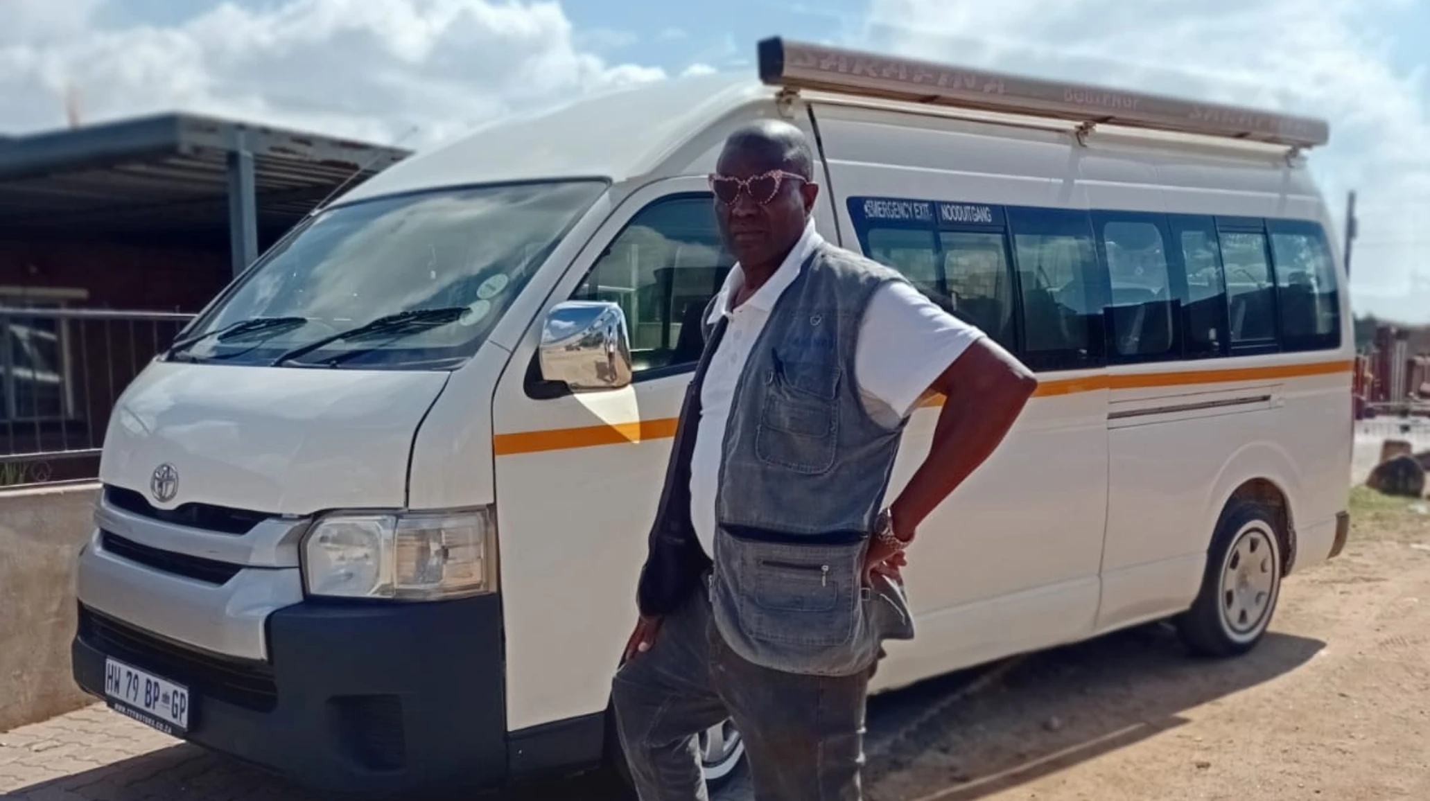Petros Malema standing besides his taxi