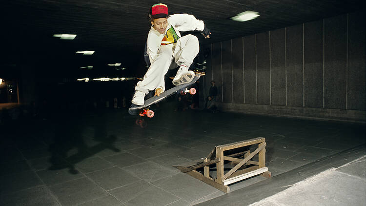Skater jumping over a ramp in the Southbank Undercroft 