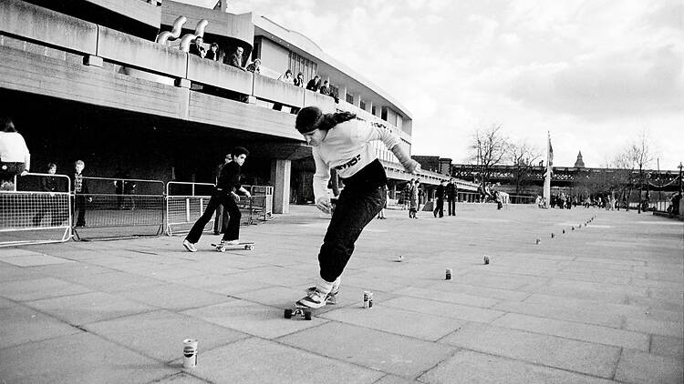 Black and white photo of Jim Slater slalom skating in the ‘70s 