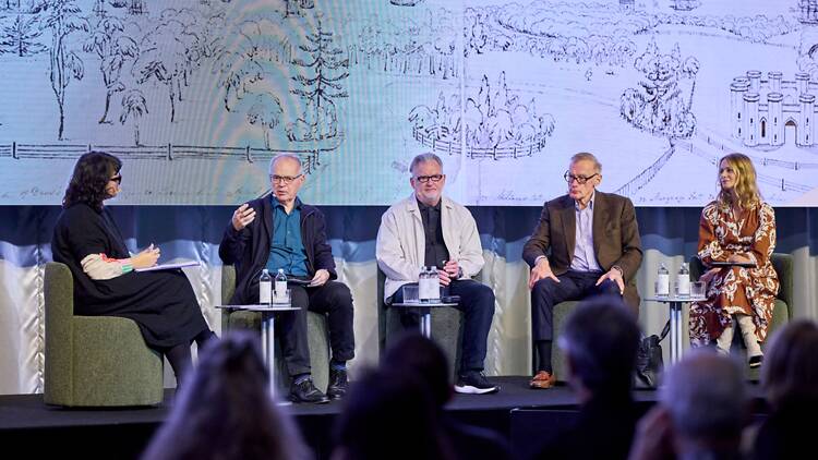 A panel of people onstage giving a talk