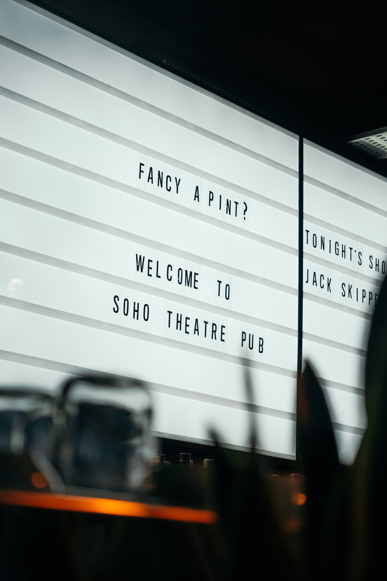 Pub board that says 'Fancy a pint? Welcome to Soho Theatre Pub'