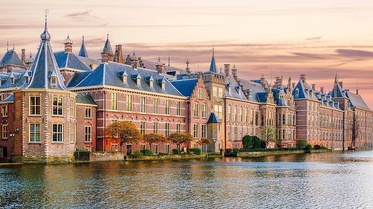 The Hague, Ridderzaal in Binnenhof with the Hofvijver lake at sunset. Meeting place of States General of the Netherlands, the Ministry. Office of the Prime Minister of Netherlands.