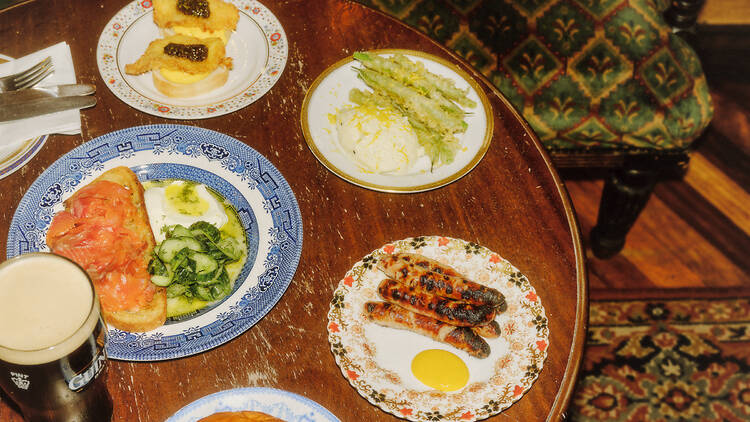 Pub table with array of dishes and a pint of guinness
