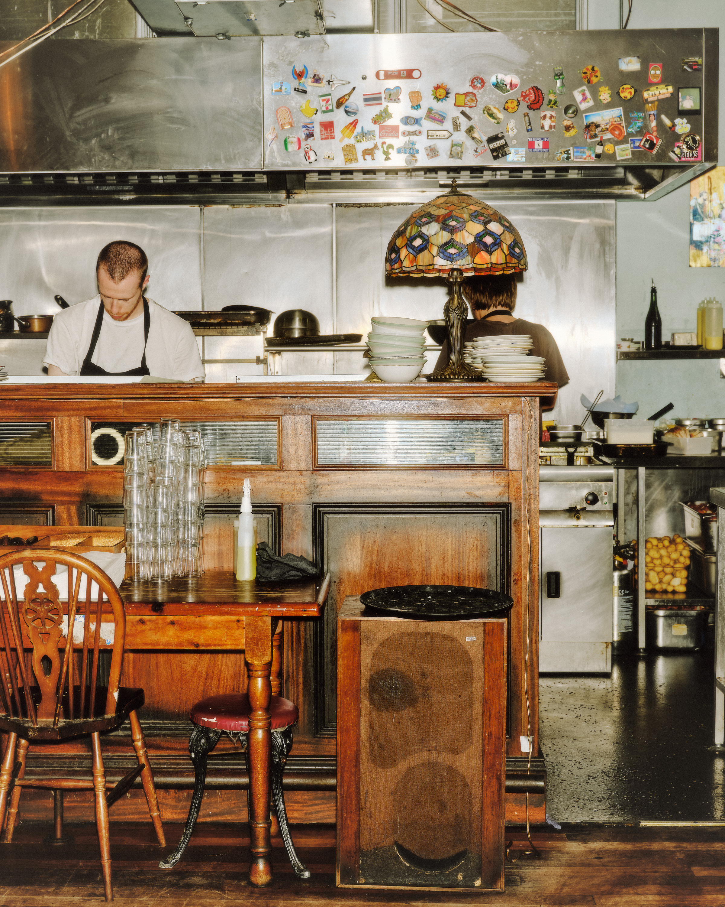 Chef in kitchen behind pub dining room