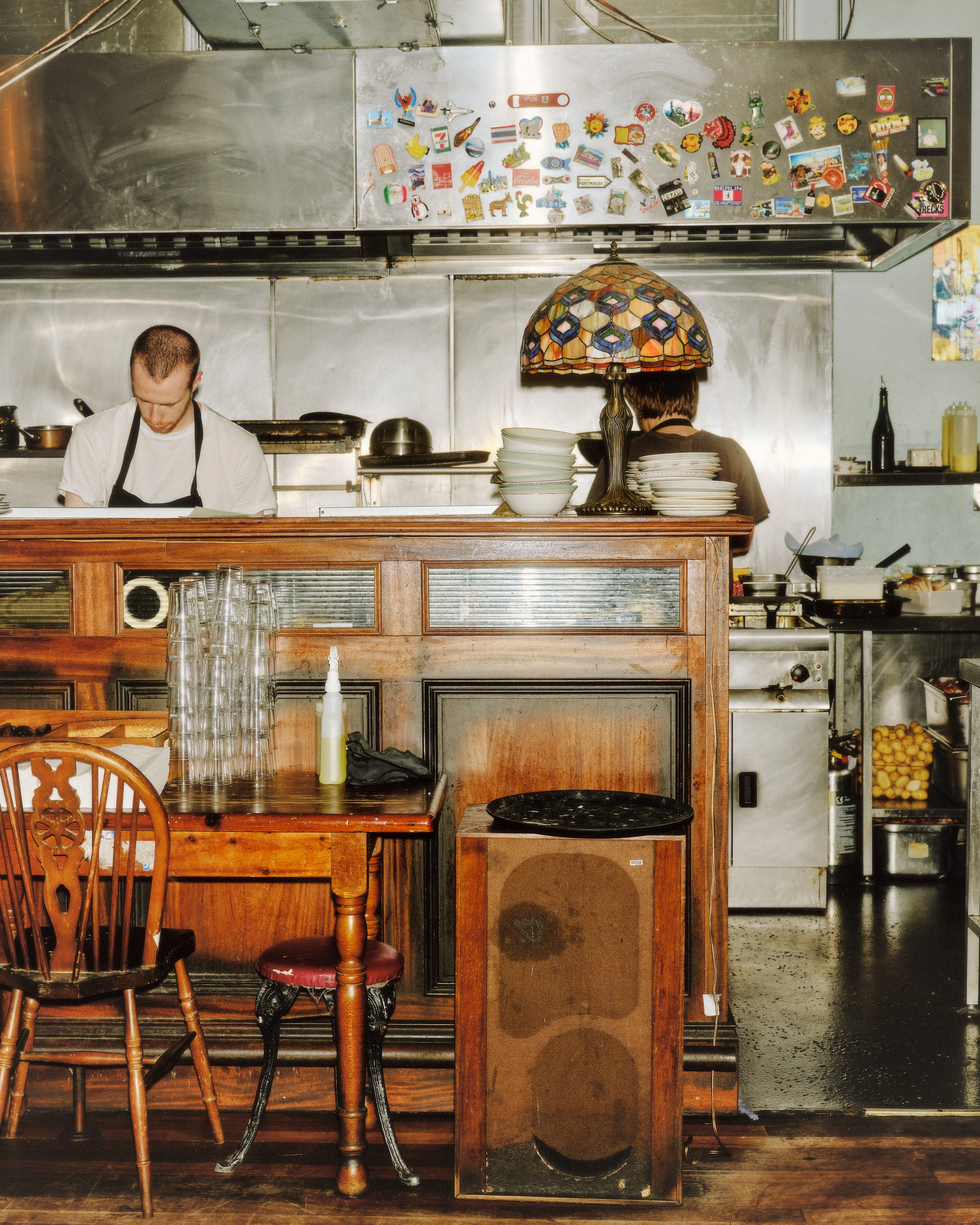 Chef in kitchen behind pub dining room