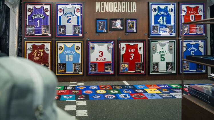 A wall of NBA jerseys framed