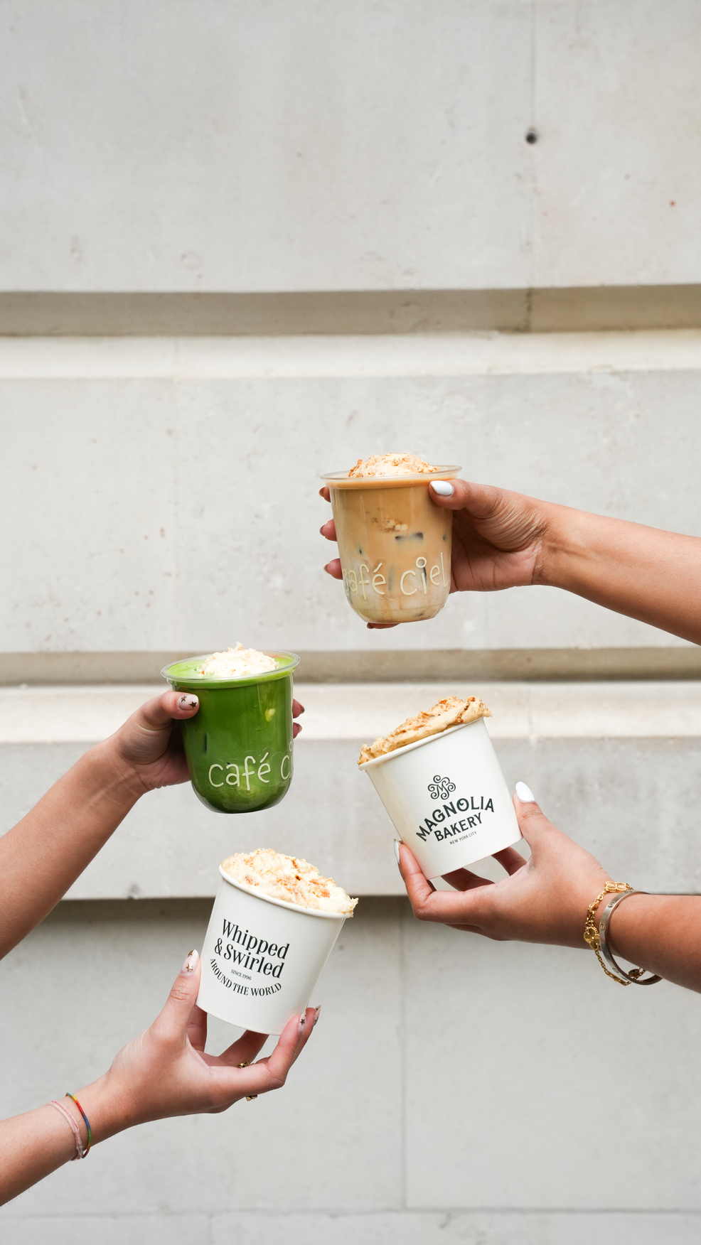 Hands holding banana pudding, iced coffee and matcha