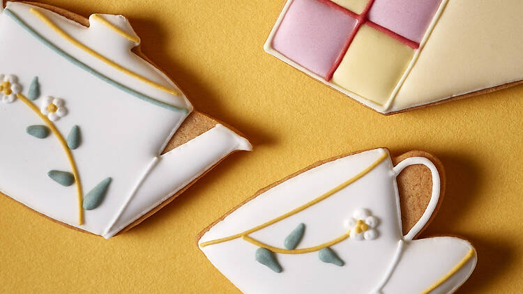 Biscuits in the shape of tea pot, tea cup and battenberg