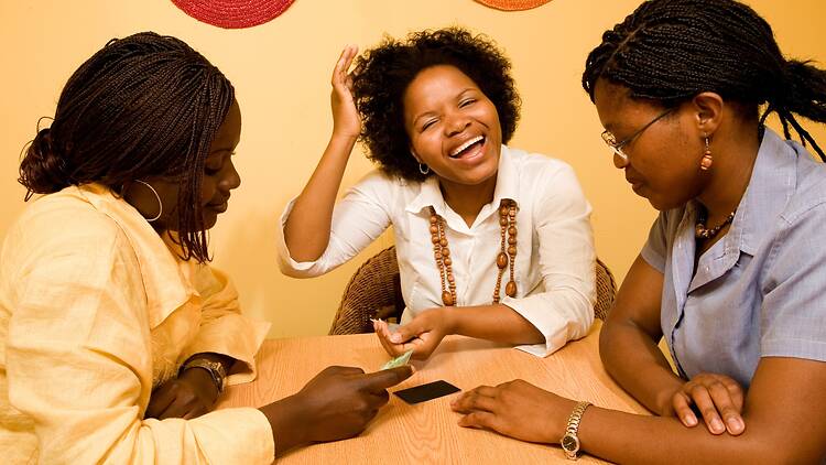 African women sitting around the table, socialising