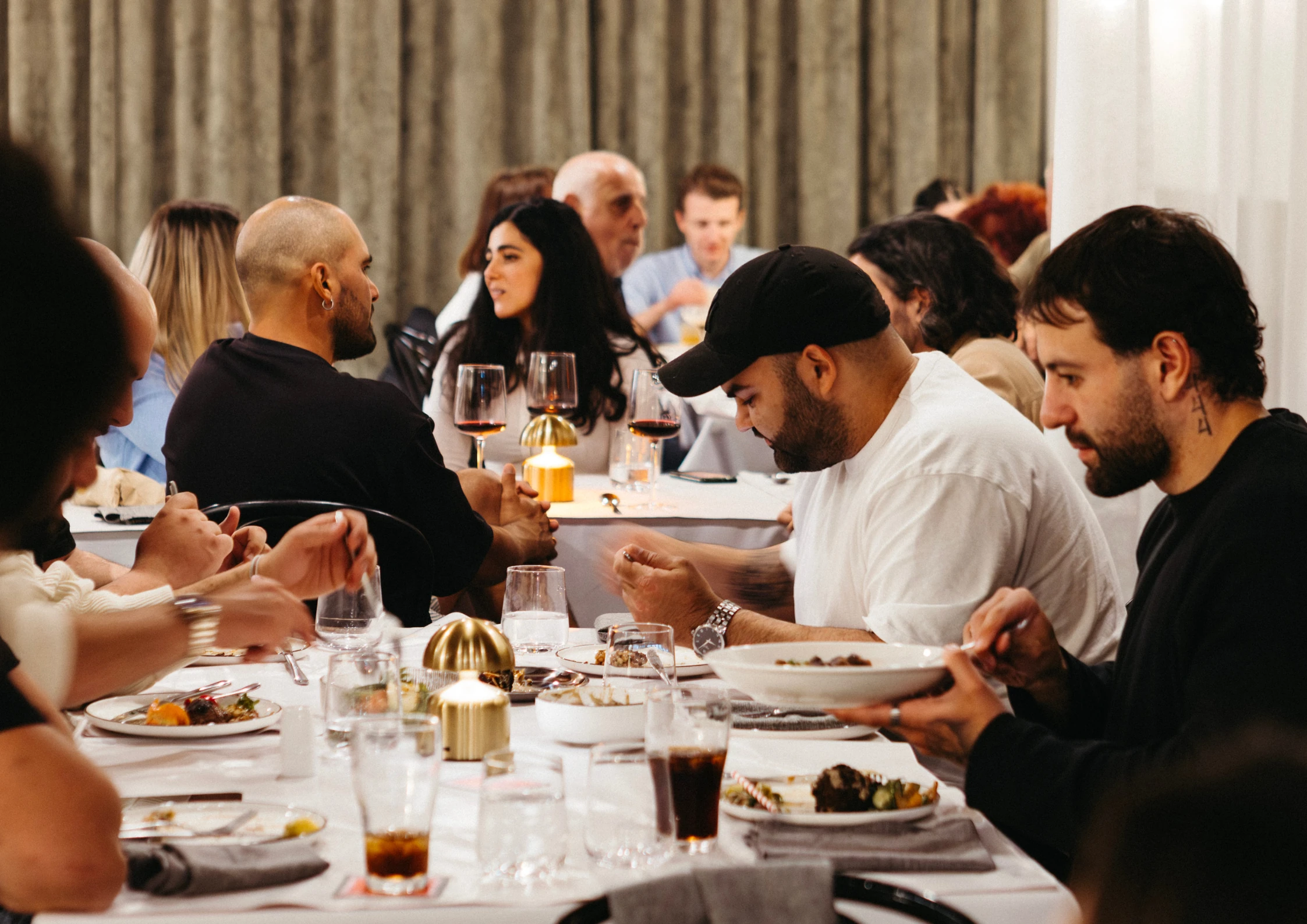 Dining guests at Sama enjoying food and drinks.