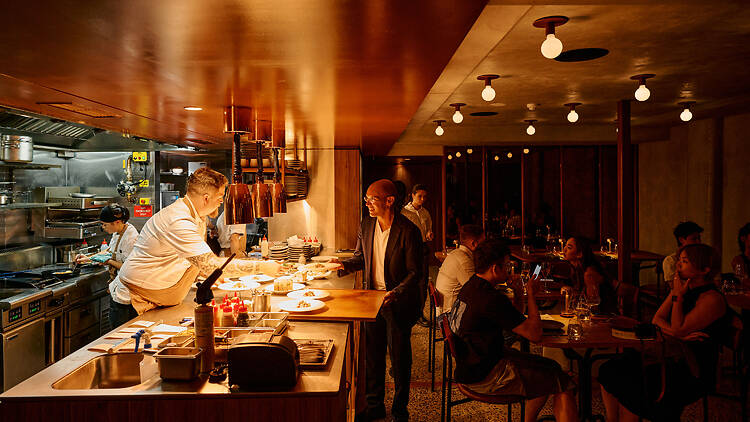 The interiors of a restaurant with an open kitchen