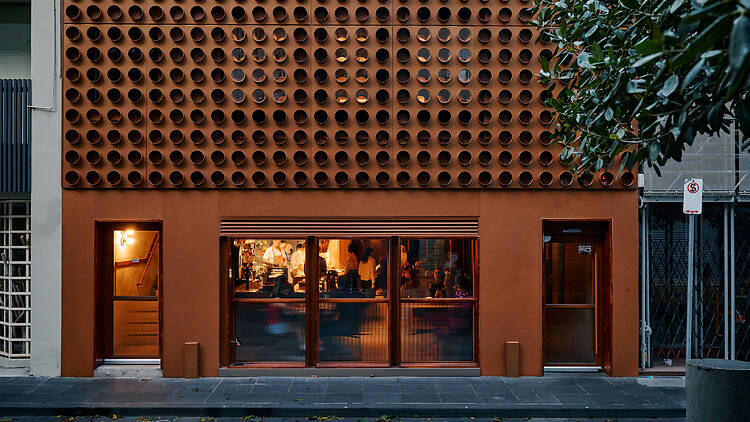 The bronze exterior of a restaurant building 