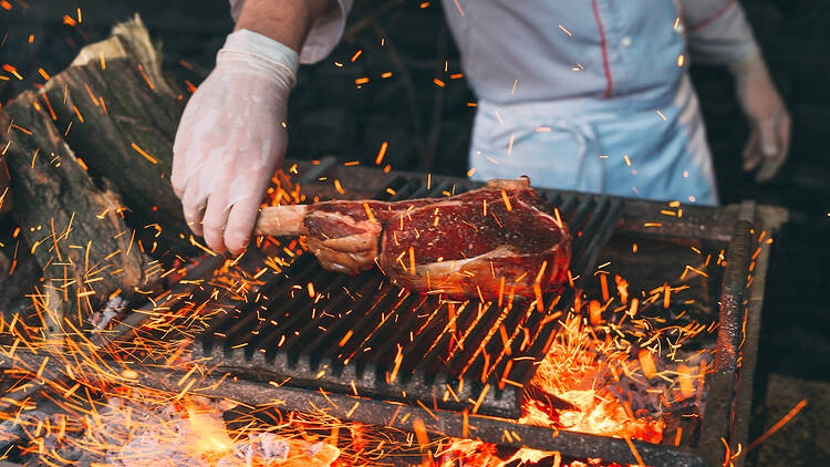 Chef Cooking steak Chef Cooking steak. Cook turns the meat on the fire