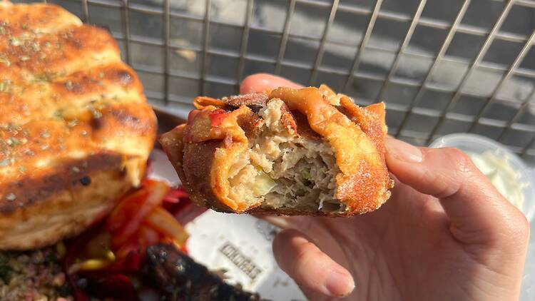 A bite of a chicken dim sim.