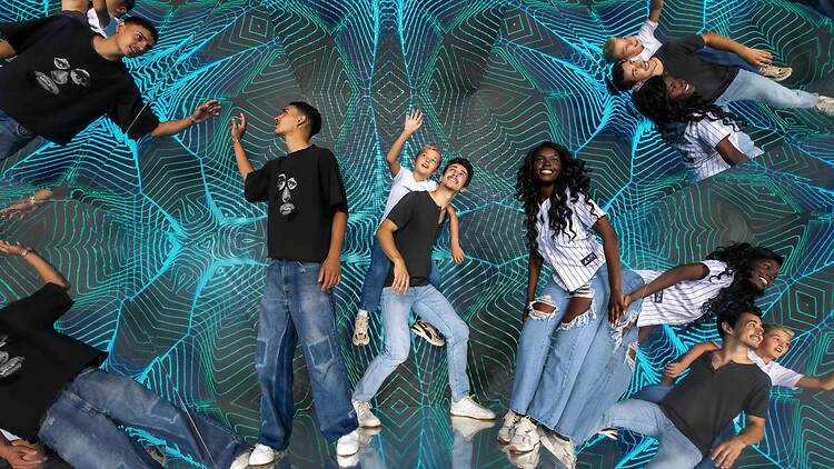 Three people experiencing the walk-in kaleidoscope at the Museum of Illusions 
