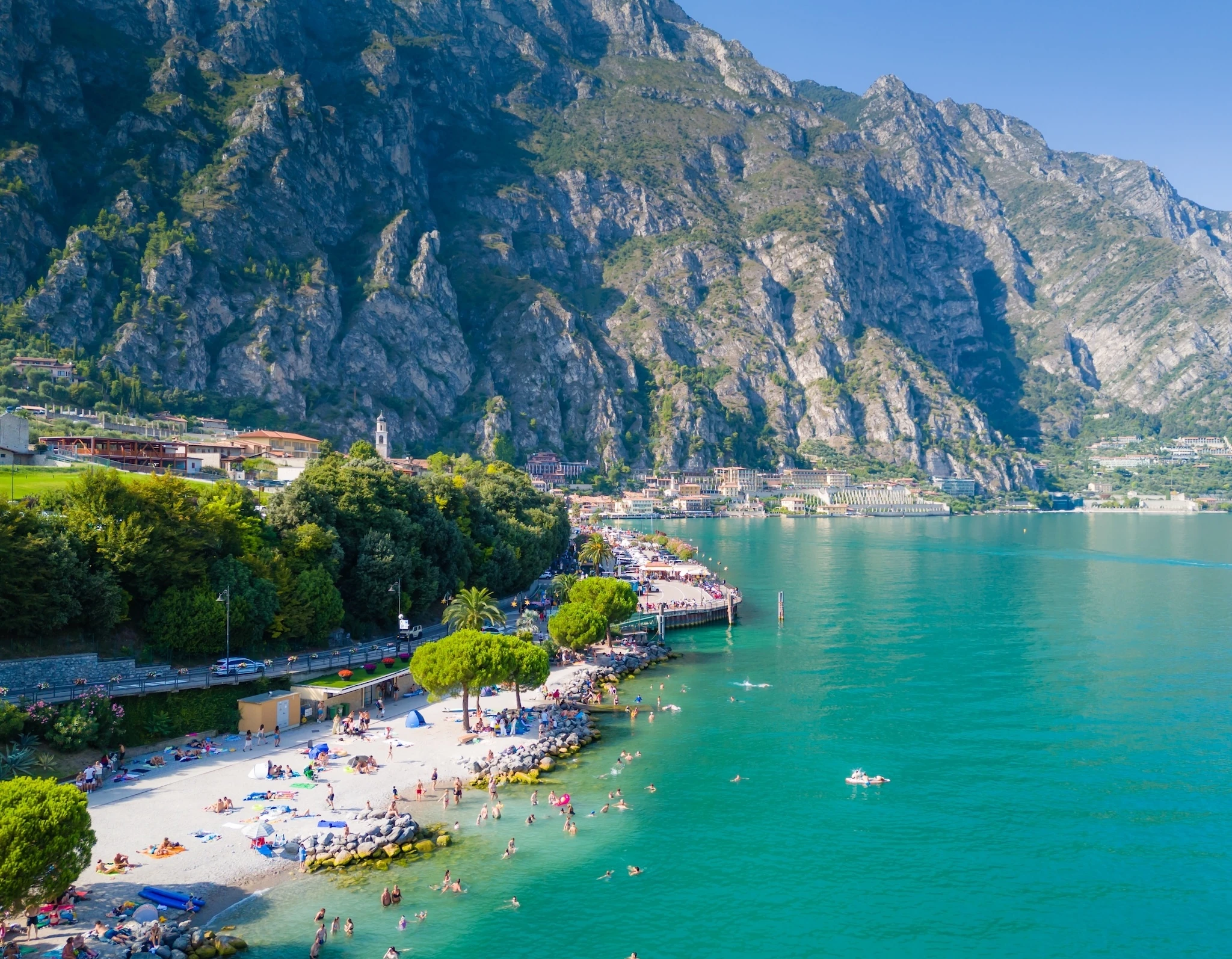 Limone sul Garda beach with people at a beach swimming and sunbathing