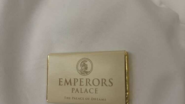 Chocolate bar placed on bed at Peermont D'oreale Grande Hotel room