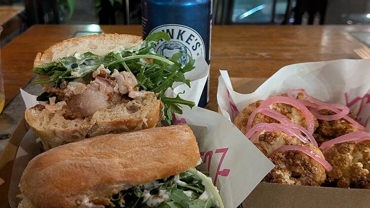 A pork roll and Hawke's Lager tinnie