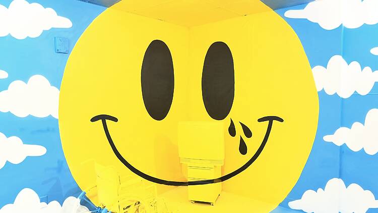 Hospital of Emotions Tommii Lim A large painted happy face and blue sky at Hospital of Emotions.