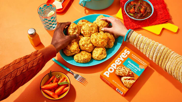 Popeyes at-home biscuit mix the photo shows the Popeyes at-home biscuit mix with a plate full of them