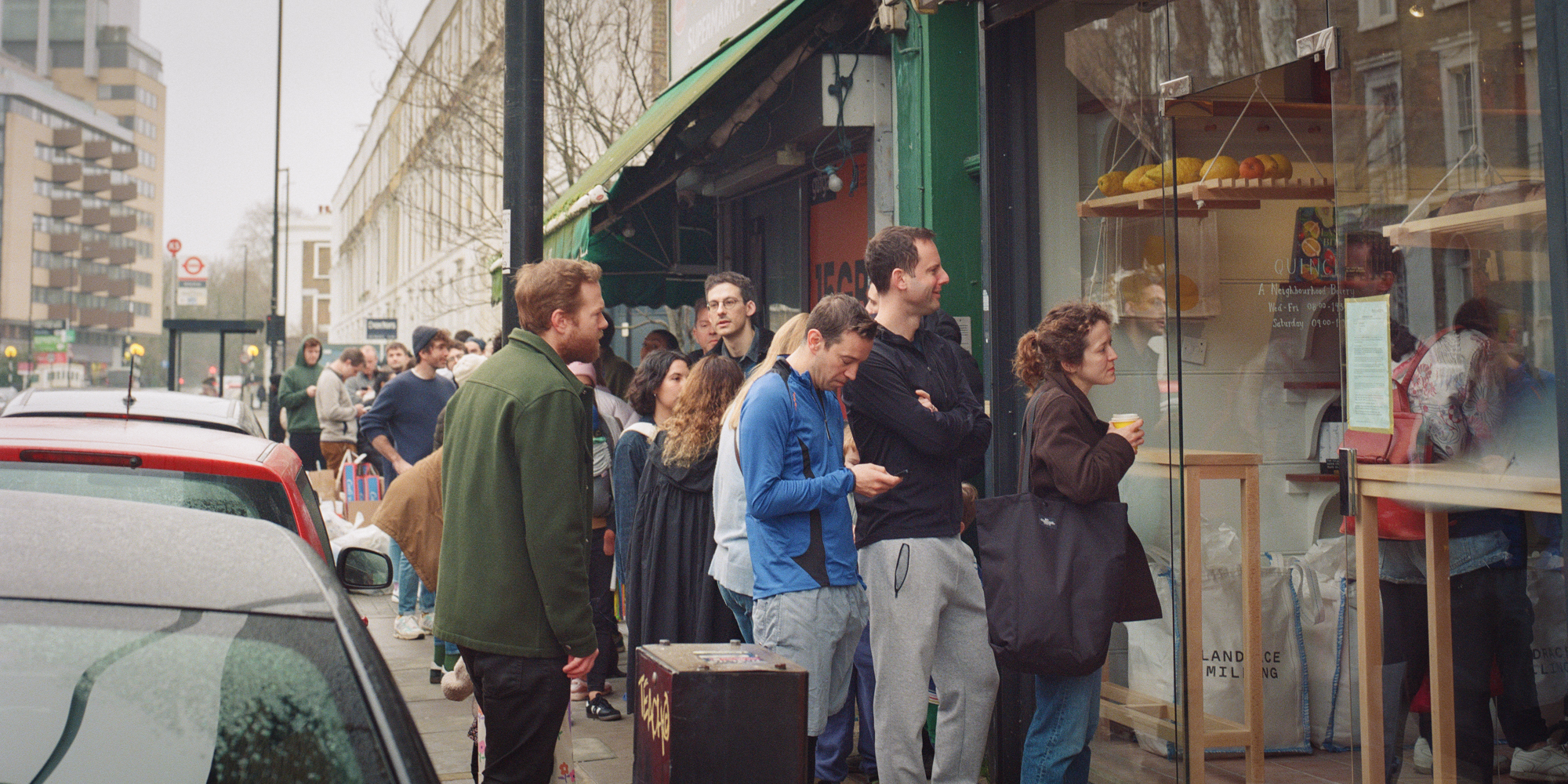 A queue of people down the street at Quince Bakery in Islington