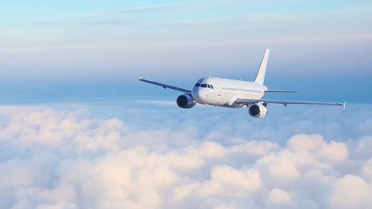 A commercial airliner flying above the clouds A commercial airliner flying above the clouds