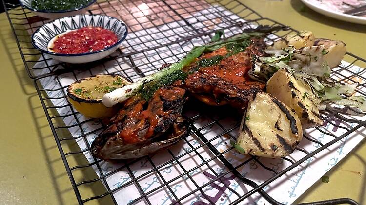 A charred fish on a cage