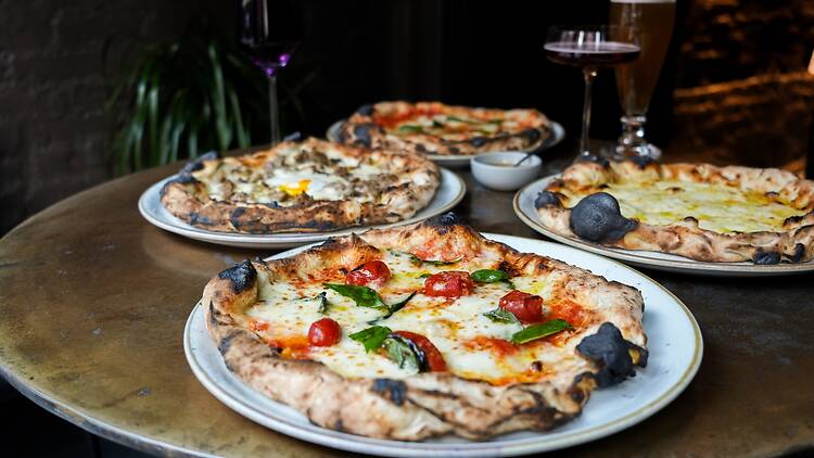 Four pizzas on a table