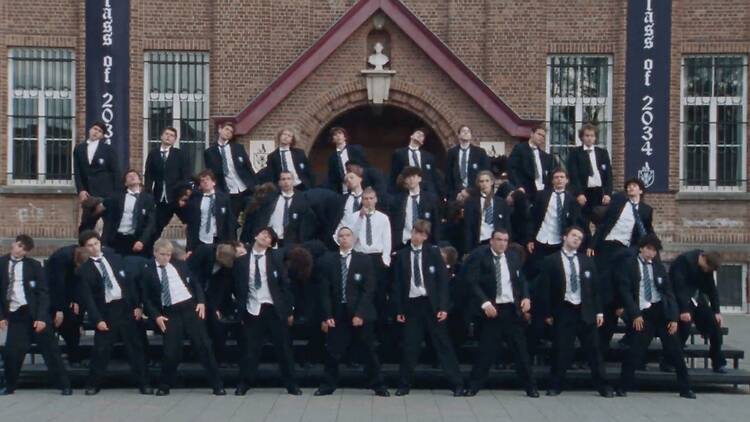 A still from 'Storm' with Yung Lean surrounded by schoolboys taking a school photo A still from 'Storm' with Yung Lean surrounded by schoolboys taking a school photo