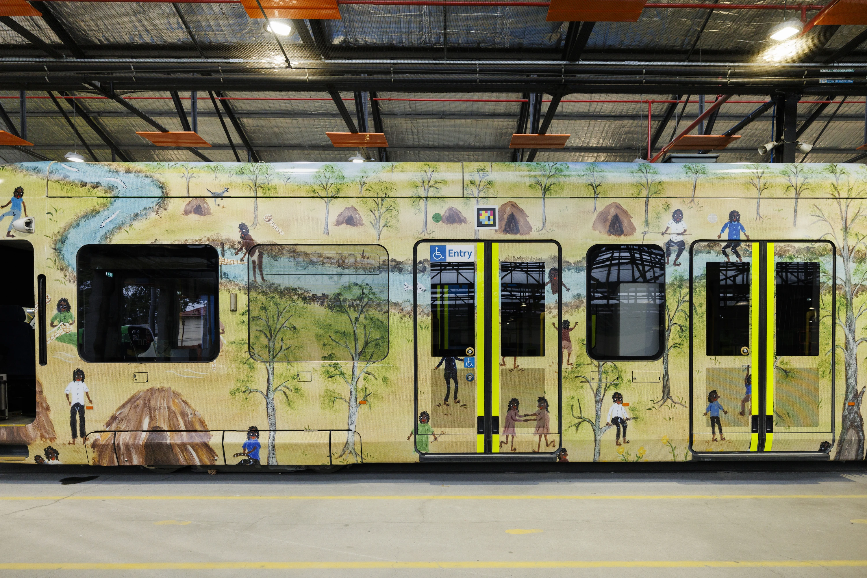 A tram wrapped in First Peoples art.