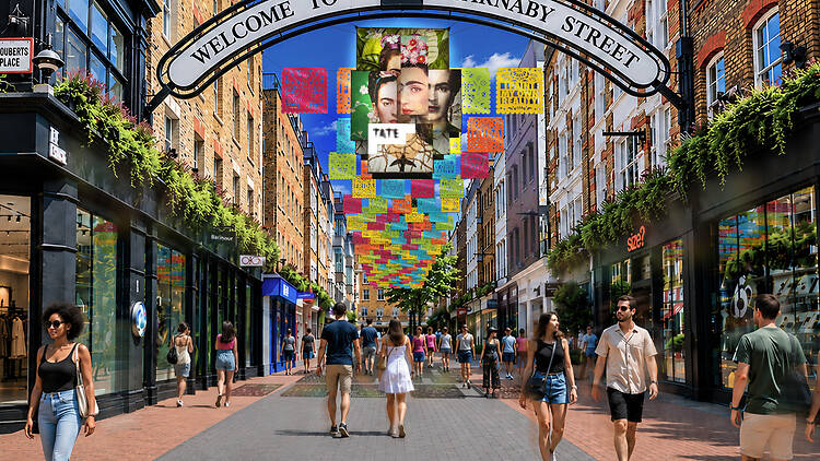 Render of Frida Kahlo installation on Carnaby Street with colourful papel picado decorations and an anamorphic mural of Frida Kahlo portraits 