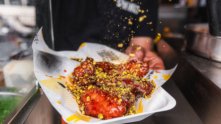 Chicken being seasoned at Fume festival