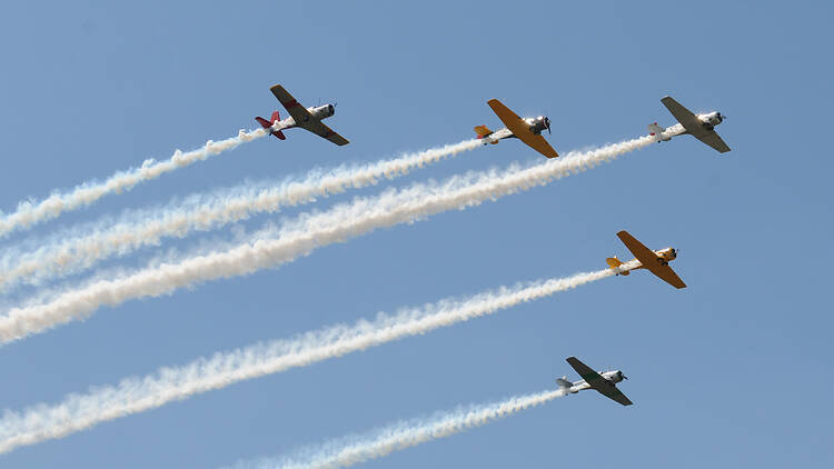 Group of vintage propeller airplanes in formation