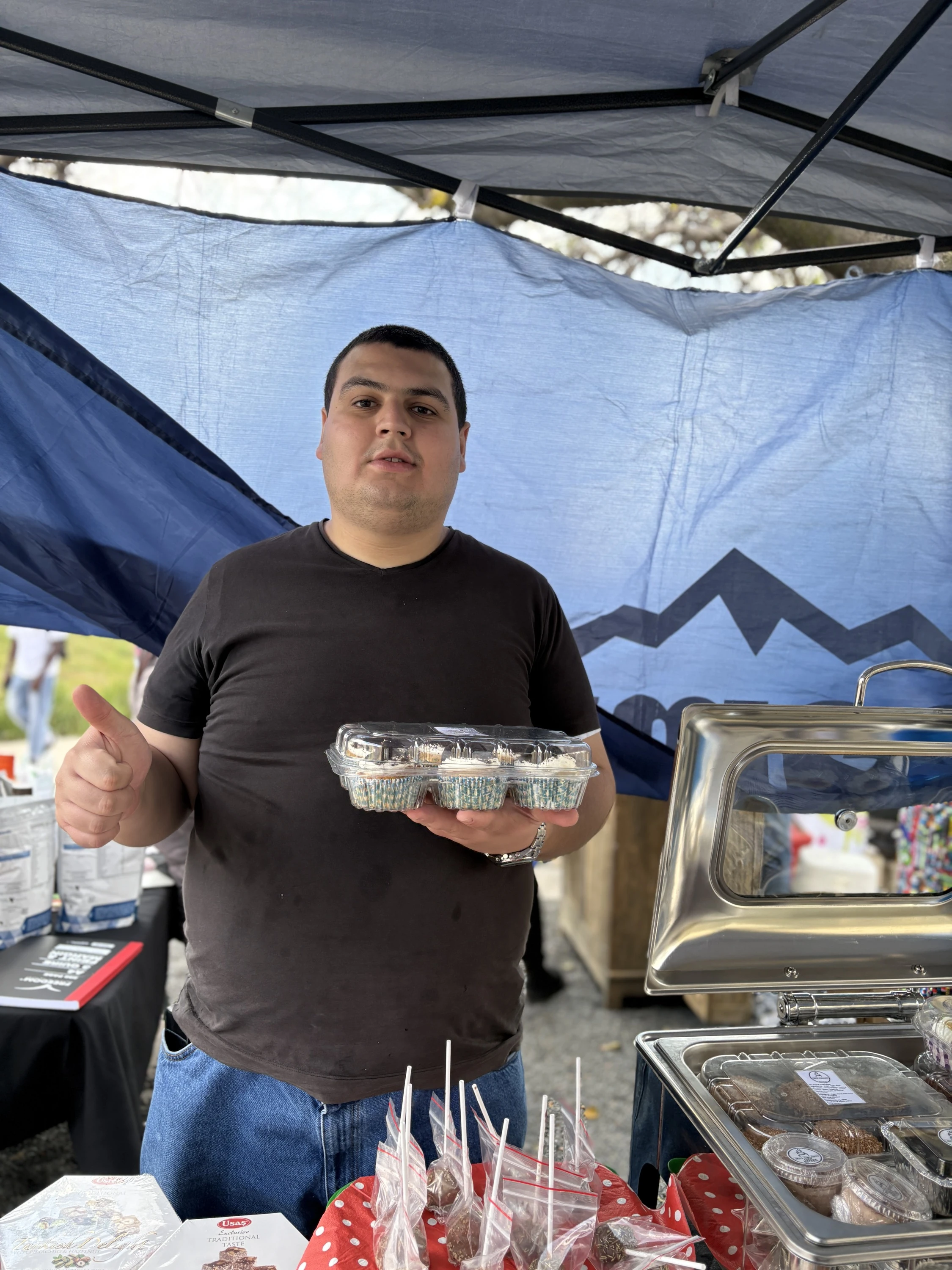 Irfan Genc holding cup cakes at a stall in Johannesburg 