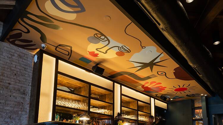 A painted mural over a bar.