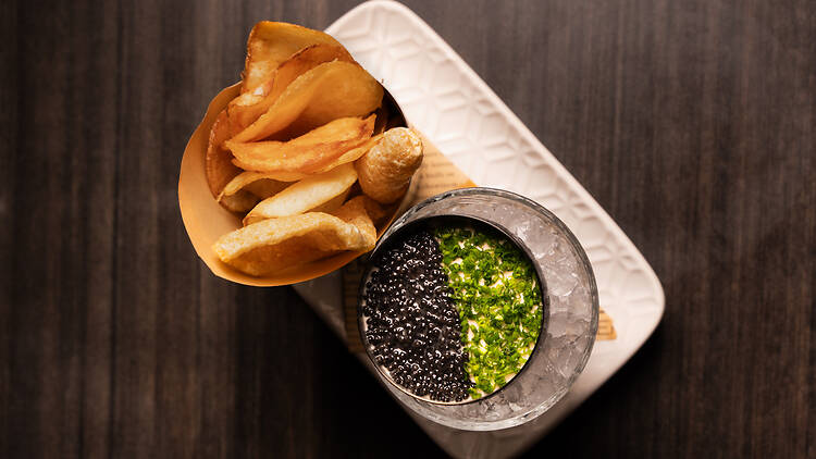 A tin of caviar served with chips.