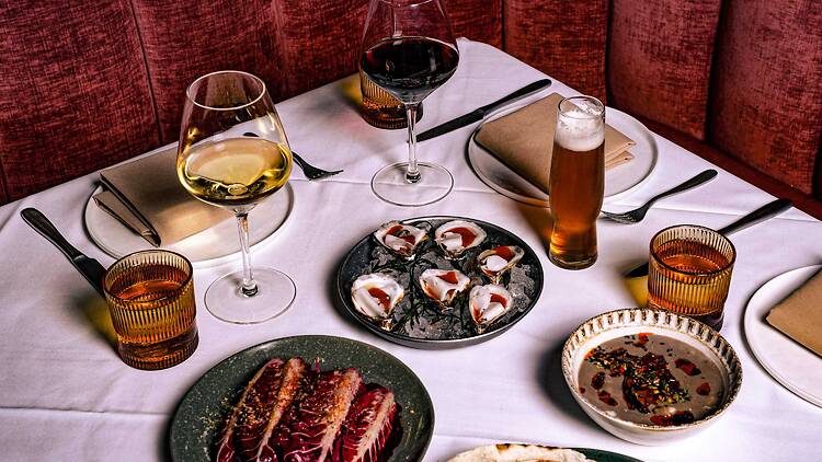 A variety of dishes and drinks on a table.