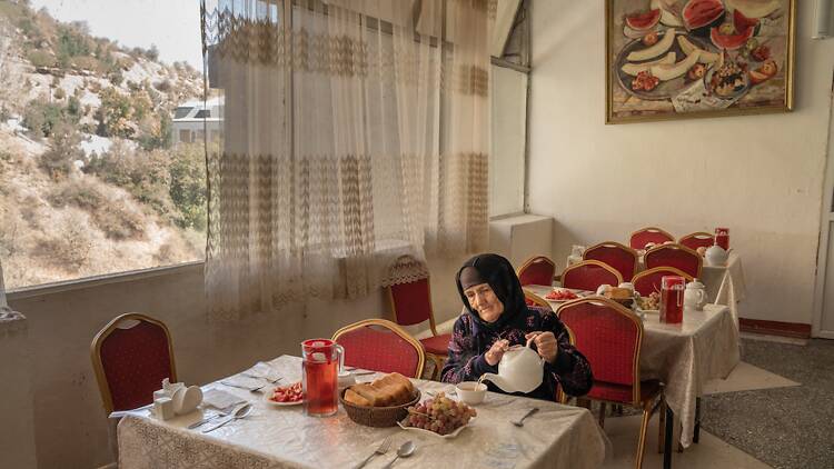 A Woman Eats in the Canteen of the Soviet-era Sanatorium A Woman Eats in the Canteen of the Soviet-era Sanatorium