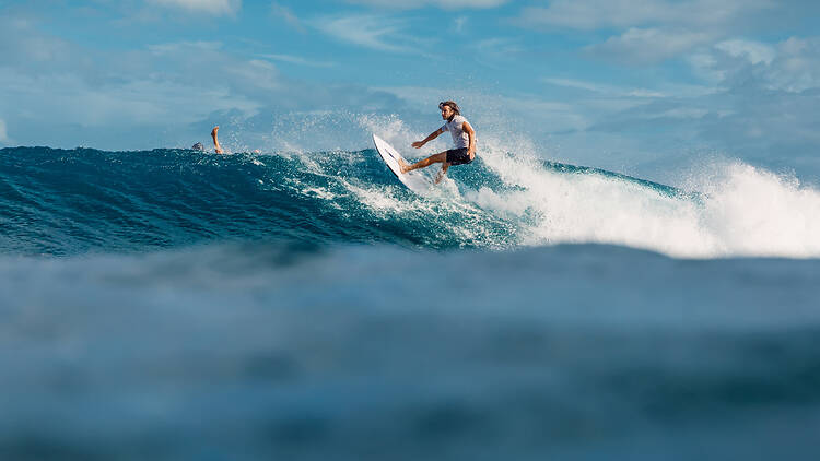 Surfer ride on surfboard on blue wave Surfer