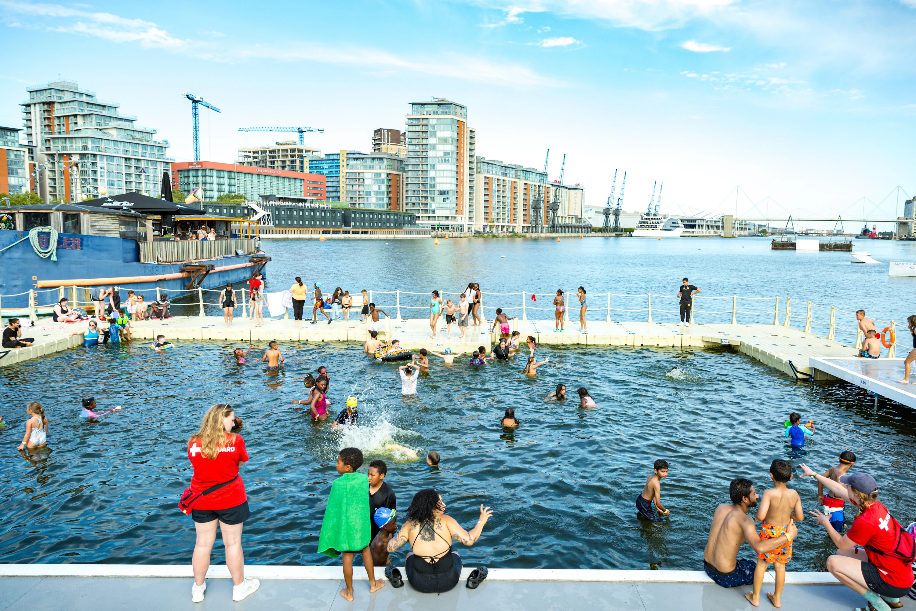Kids and adults taking a dip at Victoria Royal Docks' Summer Splash lido