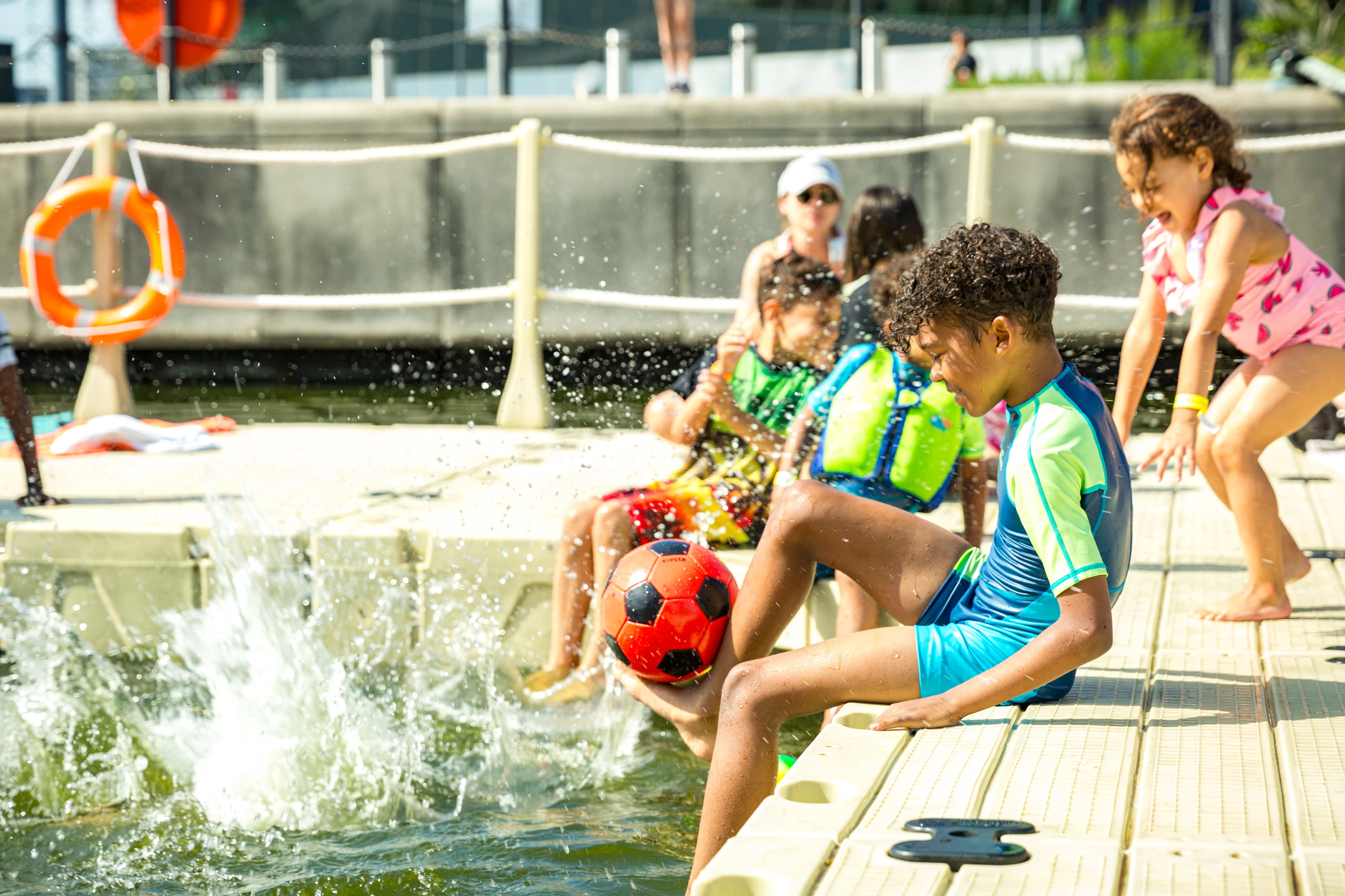 Kids playing in the water at the Victoria Royal Docks